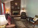 Cozy living room featuring a brick fireplace, comfortable seating, and a warm, inviting ambiance at 7316 Truelight Church Rd, Mint Hill, NC 28227