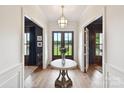 Elegant foyer featuring a hardwood floor, stylish lighting, and a view of the front yard at 735 Davidson Run Ln, Davidson, NC 28036