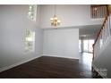 Inviting living room featuring high ceilings, staircase and beautiful hardwood floors at 7830 Shiny Meadow Ln, Charlotte, NC 28215