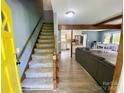 Inviting entryway with wood floors and a staircase leading to the upper level at 8742 Rittenhouse Cir, Charlotte, NC 28270