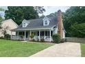 Charming exterior of home featuring a welcoming front porch, well-manicured lawn, and classic architectural details at 8742 Rittenhouse Cir, Charlotte, NC 28270