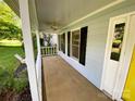 Inviting front porch with painted columns, black shutters, and ample space for outdoor seating at 8742 Rittenhouse Cir, Charlotte, NC 28270