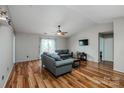 Spacious living room with vaulted ceiling, hardwood floors, ceiling fan and sliding glass doors at 9623 Duxford Ln, Charlotte, NC 28269