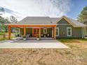 This home's rear exterior features a covered patio and outdoor seating, perfect for relaxing at 0000 Trull Hinson Rd # 2, Wingate, NC 28174