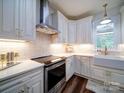 Well-lit kitchen features stainless steel appliances, white cabinets, and farmhouse sink at 0000 Trull Hinson Rd # 2, Wingate, NC 28174