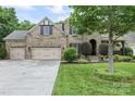 Charming brick home boasts a well-manicured lawn, lush landscaping, and a spacious three-car garage at 10620 Euclid Nw Ave, Concord, NC 28027