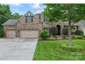 Charming brick home with a three-car garage, well-maintained lawn, and mature trees at 10620 Euclid Nw Ave, Concord, NC 28027