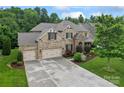 Stunning brick home featuring a three-car garage, beautiful stone accents, and well-manicured landscaping at 10620 Euclid Nw Ave, Concord, NC 28027