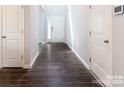 Bright foyer showcasing dark wood-look floors, a white front door and a glimpse into other rooms at 11109 Pond Valley Ct, Charlotte, NC 28269