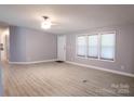 Bright, open-concept living room with hardwood flooring, neutral paint, and ample natural light at 1184 Sherwood Rd, Clover, SC 29710