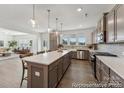 Spacious kitchen featuring a large island, pendant lighting, stainless steel appliances, and ample counter space at 125 Tangle River Dr # 51, Statesville, NC 28677