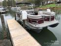 View of a 2025 Princecraft Vectra 23 Pontoon Boat resting near a wooden dock on the water at 132 Marina Ln, Mooresville, NC 28117