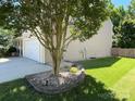 Well-kept home exterior with a tidy lawn and landscaping at 14413 Lake Crossing Dr, Charlotte, NC 28278