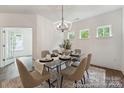 Bright dining area featuring a glass table, stylish chairs, and views of the backyard at 148 Tangle River Dr # 67, Statesville, NC 28677
