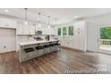 Modern kitchen with an island, counter seating, stainless steel appliances, and wood floors at 148 Tangle River Dr # 67, Statesville, NC 28677