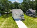 Aerial view of a light gray two-story home with an attached garage and a manicured lawn at 1645 Carolina Cir, Gastonia, NC 28054