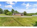 Single-story home on a well-maintained lawn, surrounded by trees, offering a peaceful and private setting at 1730 Woodbend Ln, Conover, NC 28613