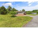 Inviting single-story home with manicured lawn, complemented by lush greenery and a serene neighborhood setting at 1730 Woodbend Ln, Conover, NC 28613