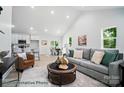 Bright living room featuring neutral tones, a vaulted ceiling, and an open concept design to the kitchen and dining room at 2116A Glenwood St, Kannapolis, NC 28083