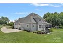 Expansive backyard features a well-maintained lawn, patio area, and screened-in porch at 224 Hidden Meadows Dr, Mooresville, NC 28117