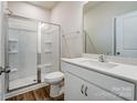Modern bathroom with a glass-enclosed shower, white vanity with sink, and neutral wall color at 2648 Tillman St, Monroe, NC 28112