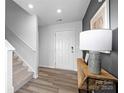 Bright foyer featuring light wood floors, white walls, and stairs at 3064 Ora Smith Rd, Lincolnton, NC 28092