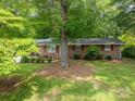 Quaint single-story home with a beautiful tree in the front yard and healthy green grass at 3120 7Th Street Ne Dr, Hickory, NC 28601