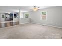 Open-concept living room featuring new carpet and neutral walls, with sightlines to the kitchen at 352 18Th Ne Ave, Hickory, NC 28601