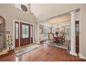 Elegant entryway with hardwood floors, chandelier, and a dining area beyond at 405 Deer Brush Ln, Waxhaw, NC 28173