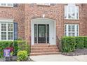 Close up of the brick entryway, showing the front door, stairs, and trimmed shrubs at 405 Deer Brush Ln, Waxhaw, NC 28173