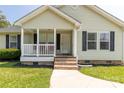 Inviting front porch with brick steps and white railing, enhancing curb appeal and providing a welcoming entrance at 4285 Palmer Lloyd Rd, Lancaster, SC 29720