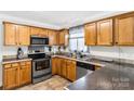 Well-lit kitchen with wood cabinetry, stainless steel appliances, and a neutral countertop at 4285 Palmer Lloyd Rd, Lancaster, SC 29720