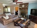 Cozy living room with a brick fireplace, ceiling fan, and comfortable furnishings at 4337 Gelinda Ct, Gastonia, NC 28056