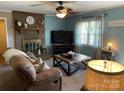 Relaxing living room with a brick fireplace, ceiling fan, and large window at 4337 Gelinda Ct, Gastonia, NC 28056