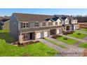 Aerial view of townhomes with brick facade, attached garages, and green lawns at 502 Mt. Mitchell Ave # 502, Gastonia, NC 28052