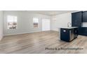Spacious living area with hardwood floors, white walls, and large windows for natural light at 502 Mt. Mitchell Ave # 502, Gastonia, NC 28052