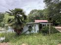 Exterior of a weathered building surrounded by dense foliage, featuring a unique round window and red roof at 528 Waring Ct # Lot 3, Fort Mill, SC 29707