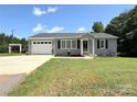 Attractive single-story home featuring gray siding, black shutters, and well-maintained landscaping at 5323 Flat Creek Rd, Heath Springs, SC 29058