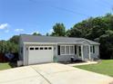 Attractive single-story house with gray siding, manicured lawn, and a spacious driveway at 5323 Flat Creek Rd, Heath Springs, SC 29058