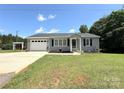 Well-kept home features an attached garage, neat landscaping, and a welcoming front entrance at 5323 Flat Creek Rd, Heath Springs, SC 29058