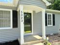 A charming front entrance featuring a wreath and classic white pillars at 5323 Flat Creek Rd, Heath Springs, SC 29058