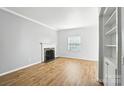 Bright living room with hardwood floors, a decorative fireplace, and ample natural light at 5947 Quail Hollow Rd # A, Charlotte, NC 28210