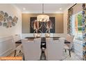 Elegant dining room with modern chandelier, stylish artwork, and a window at 6328 Busch Way, Midland, NC 28107