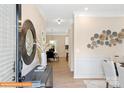 Inviting entryway with hardwood floors, decorative mirror, and art leading to dining area at 6328 Busch Way, Midland, NC 28107