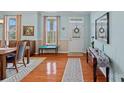 Inviting home entryway with hardwood floors, soft blue walls, a decorative rug, and ample natural light at 7339 Millstone Sw Cir, Concord, NC 28025
