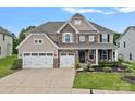 Charming two-story home with a three car garage, stone accents, a manicured lawn and covered front porch at 7339 Millstone Sw Cir, Concord, NC 28025
