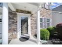 Inviting entryway with a glass door, stone accents, and manicured landscaping, creating curb appeal at 1012 Kings Bottom Dr, Fort Mill, SC 29715