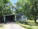 Charming home featuring a covered carport, inviting front porch, and mature trees at 1051 S Brady Ave, Newton, NC 28658