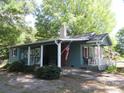 Charming home with a covered parking area, front porch, and flag display at 1051 S Brady Ave, Newton, NC 28658