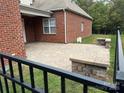 Spacious brick-paved backyard patio, perfect for entertaining, with a view of the green landscape at 10715 Tom Short Rd, Charlotte, NC 28277